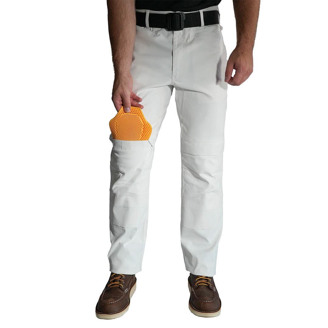 Person wearing white pants holding a yellow object on a white background. Thrive Work Wear by Paint Life Supply Co.
